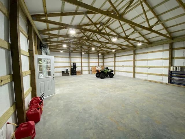 Interior shop view from the side door angle showing ATV and the working space