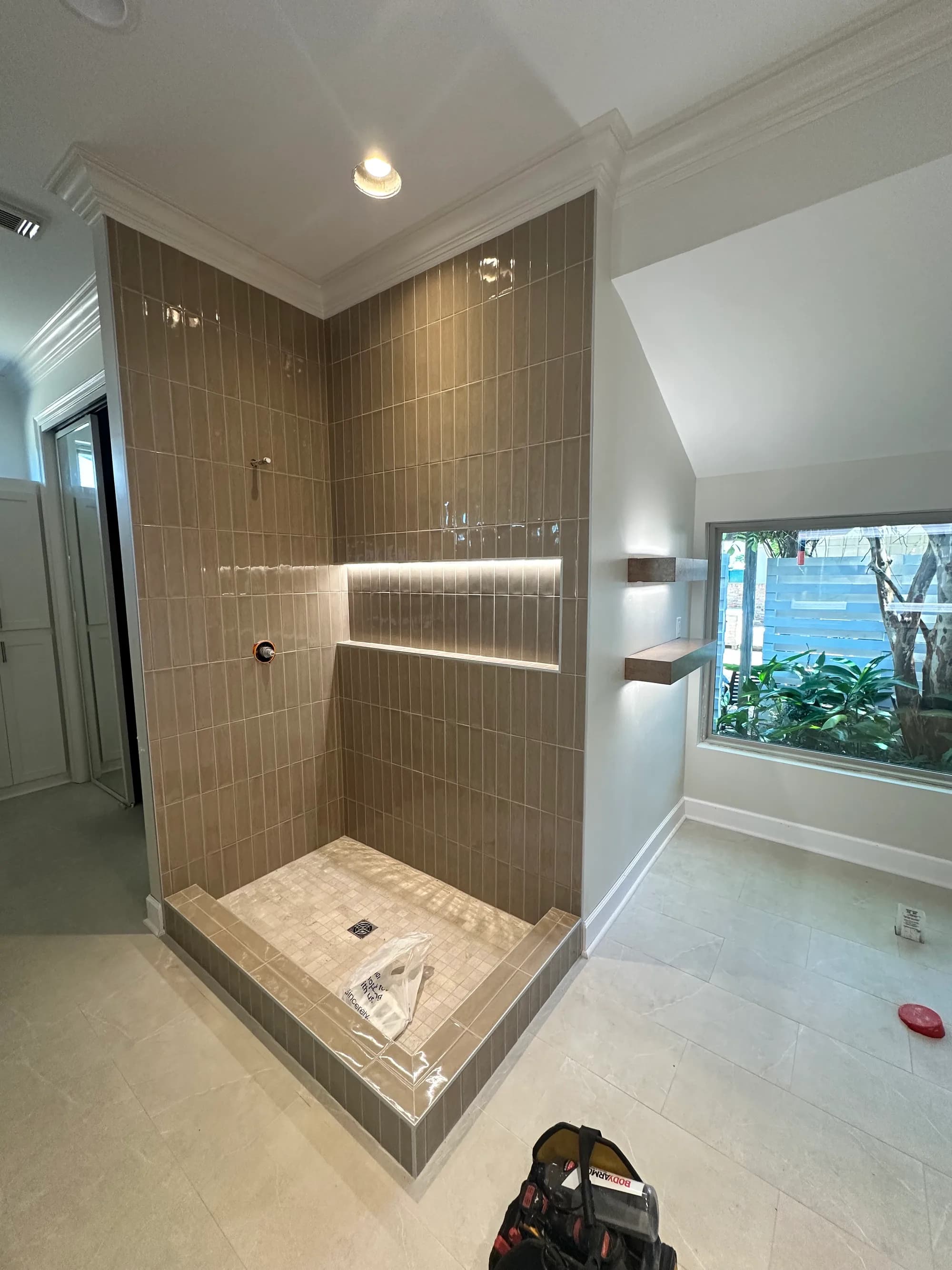 Master bathroom shower with lit tile niche